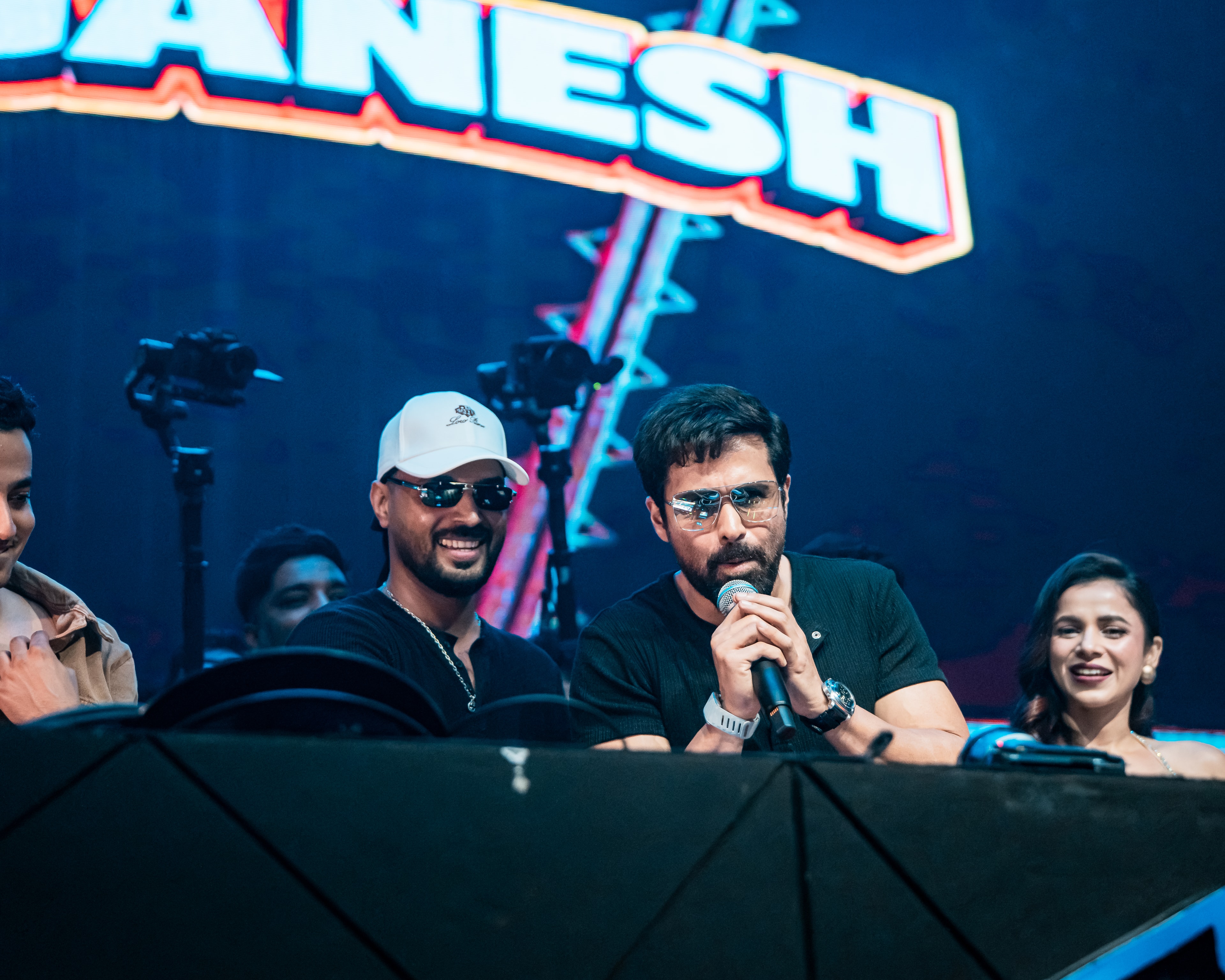 DJ Ganesh beside Emraan Hashmi at the desk as he takes the mic
