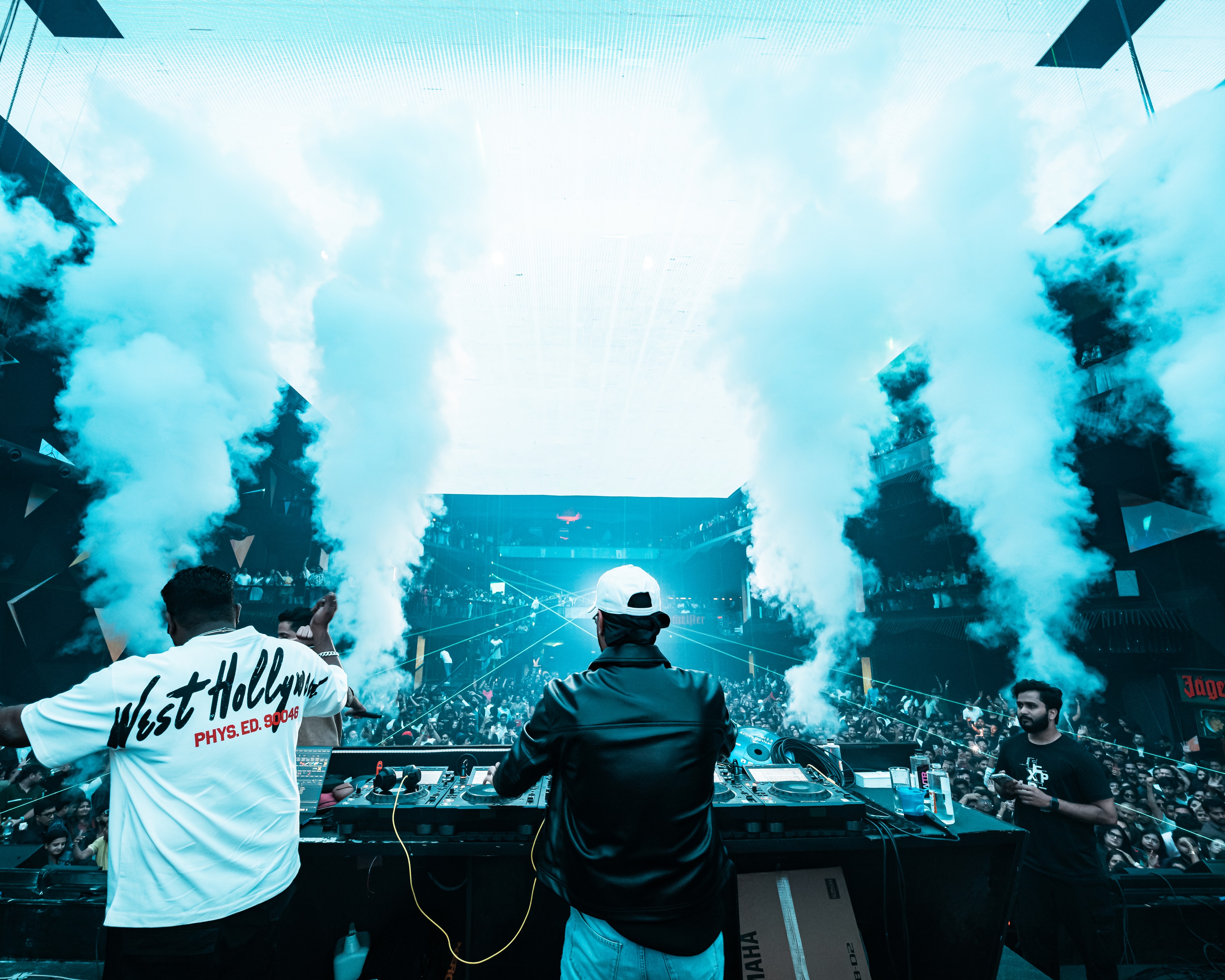 DJ Ganesh at the decks, smoke cannons firing over the crowd